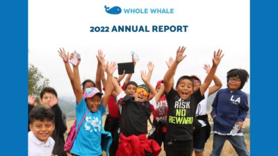 photo of happy kids with their arms in the air on a field trip as an example image for a an annual report with the text 2022 Annual Report